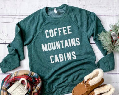 Super soft pullover sweatshirt featuring the words "Coffee Mountains Cabins." The perfect top for a mountain getaway. Design is available in black or white ink. Choose from sweatshirt or t-shirt.