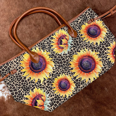 Weekender tote bag featuring sunflowers on a leopard/cheetah print background - the perfect gift for the traveler in your life!